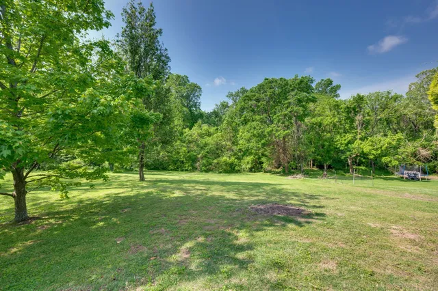a view of a house with a yard and garage