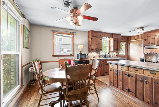 a view of a dining room with furniture a chandelier and wooden floor