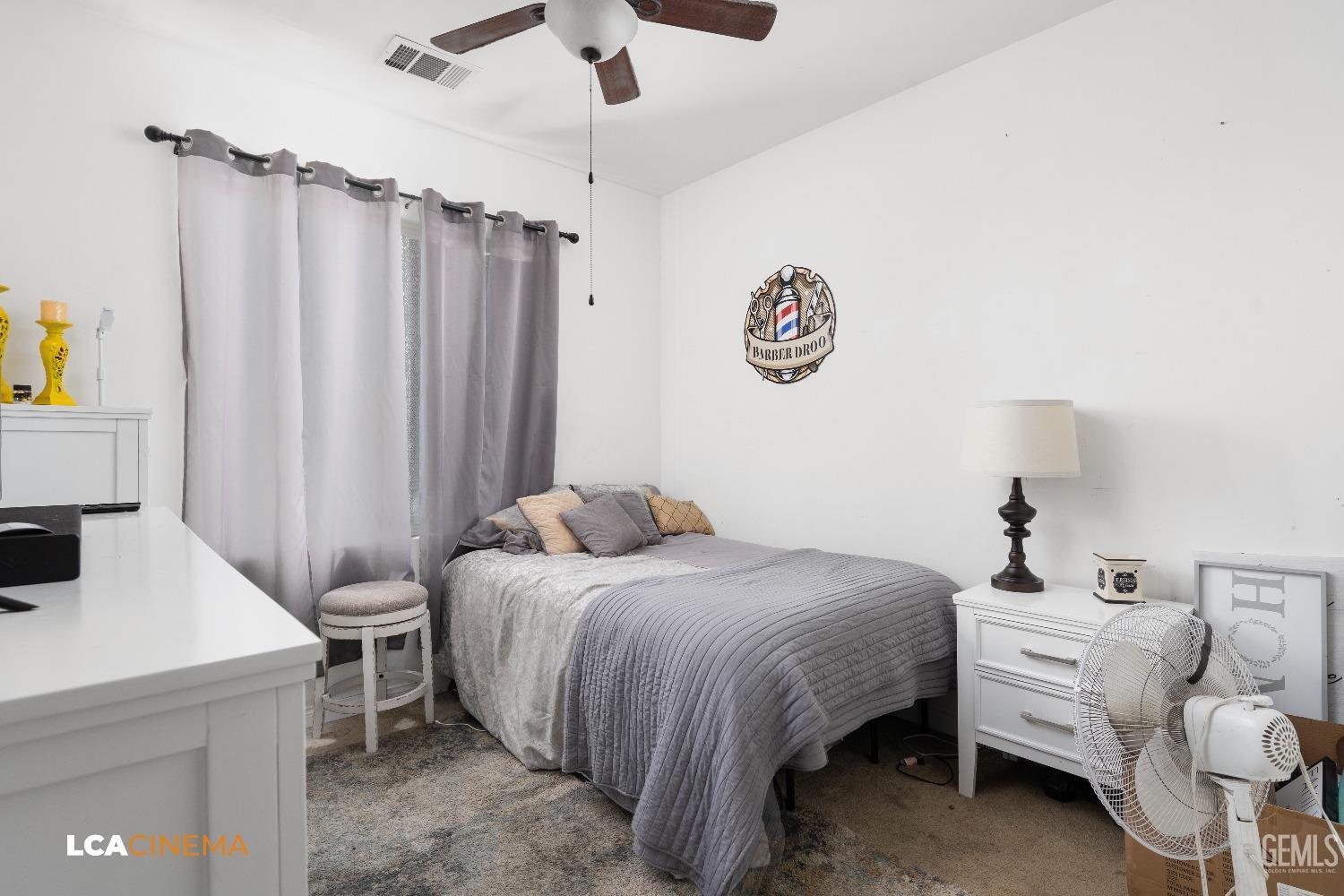 Undisclosed Address Bakersfield, CA 93304 - Photo 13 of 19 a bedroom with a bed and a table in it