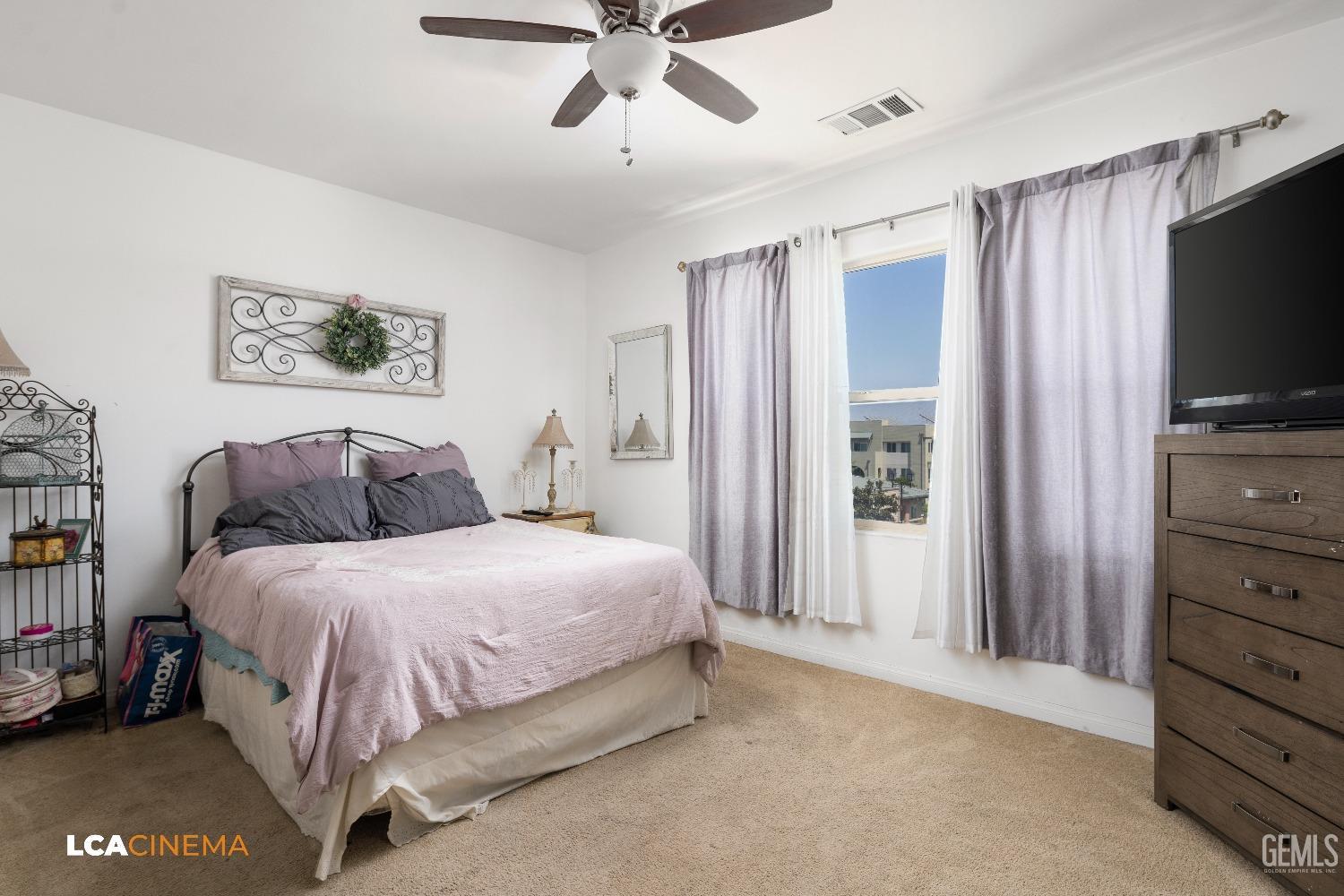 Undisclosed Address Bakersfield, CA 93304 - Photo 14 of 19 a bedroom with a bed and a flat screen tv