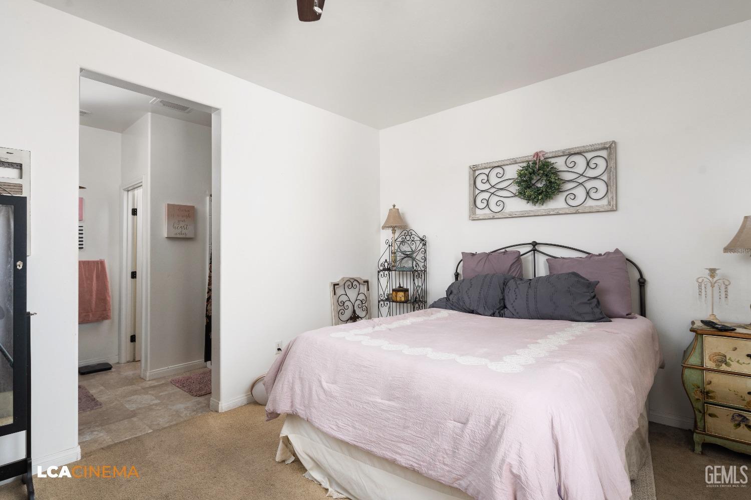 Undisclosed Address Bakersfield, CA 93304 - Photo 15 of 19 a bedroom with a bed and a painting on the wall
