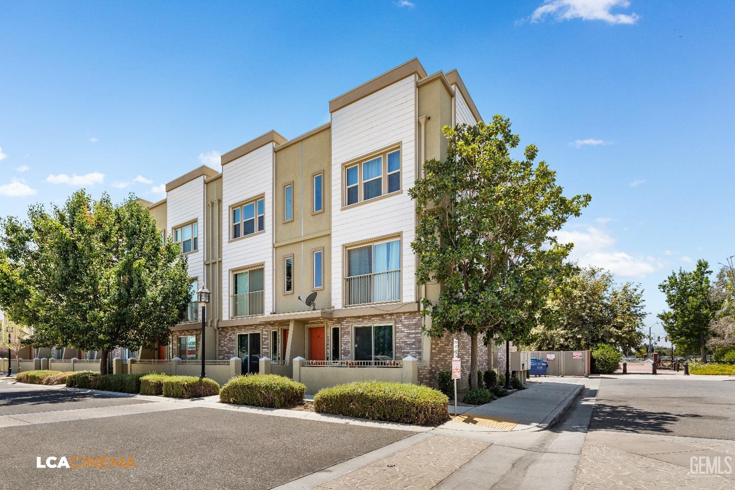 Undisclosed Address Bakersfield, CA 93304 - Photo 2 of 19 a front view of a residential apartment building with a yard