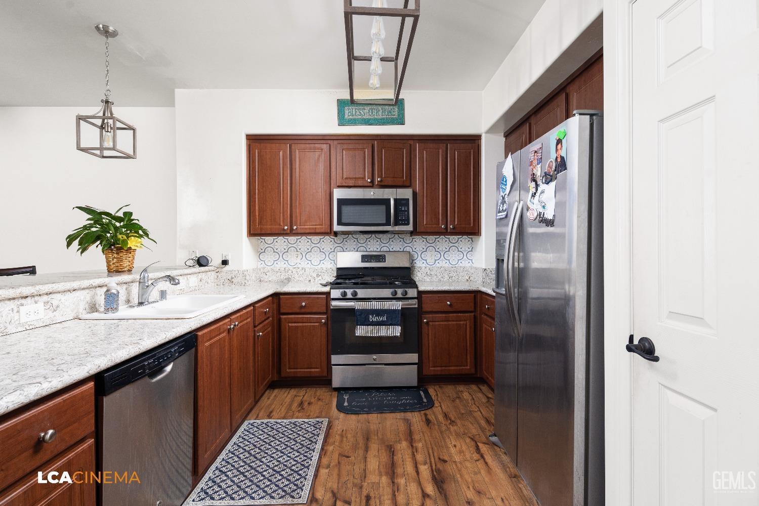 Undisclosed Address Bakersfield, CA 93304 - Photo 4 of 19 a kitchen with granite countertop a refrigerator stove top oven and sink