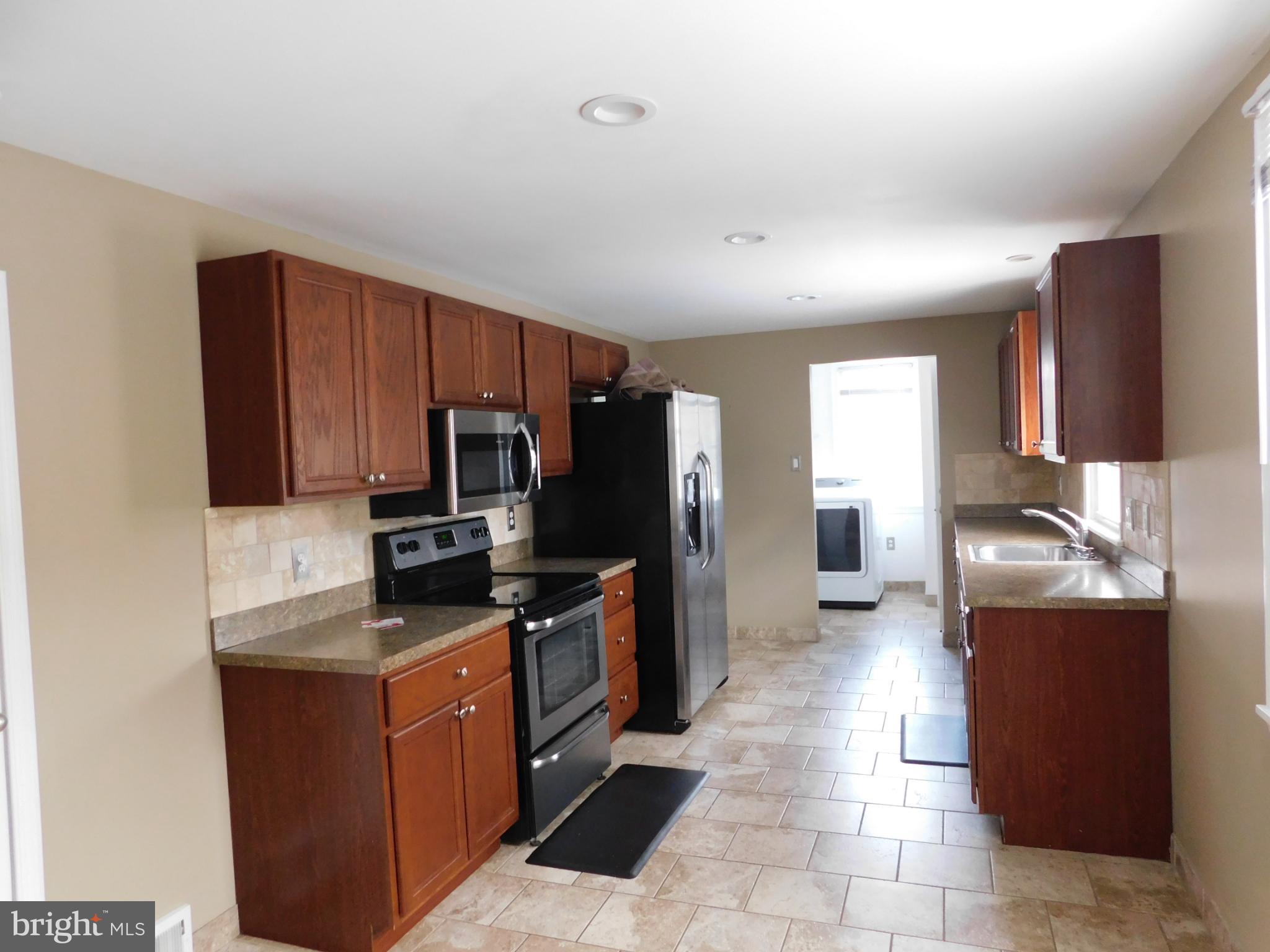 737 Churchville Road Southampton, PA 18966 - Photo 3 of 10 a kitchen with stainless steel appliances granite countertop a refrigerator stove and sink