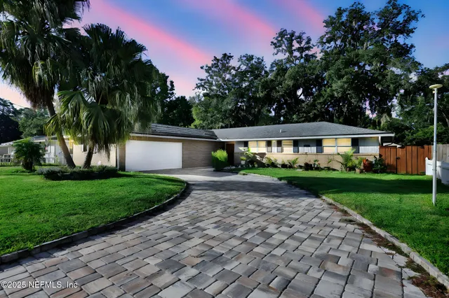 a front view of house with yard and green space