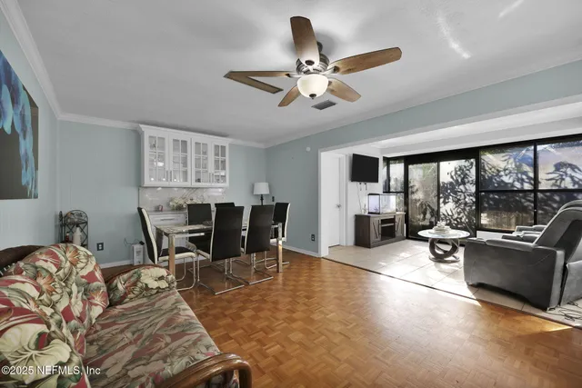 a view of a dining room with furniture and chandelier