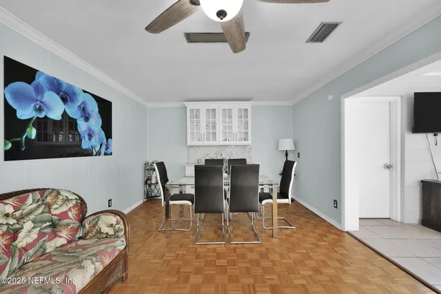 a view of a dining room with furniture and wooden floor