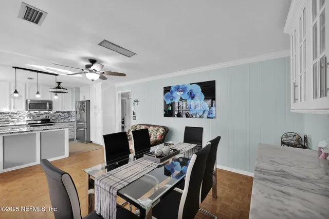a living room with furniture a flat screen tv and a large window