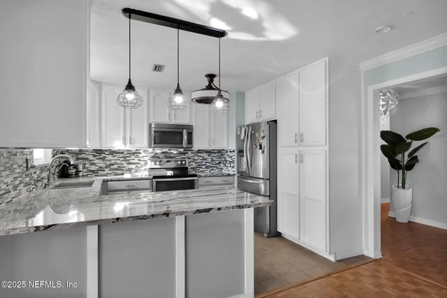 a kitchen with sink cabinets and stove
