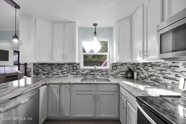 a kitchen with a sink stove and cabinets