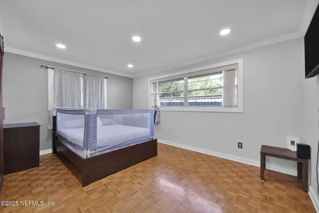 a spacious bedroom with a bed and a couch