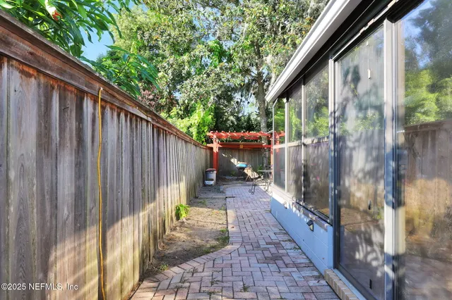 front view of a house with a yard and potted plants