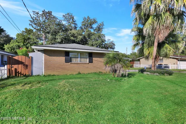 a front view of house with yard and outdoor seating