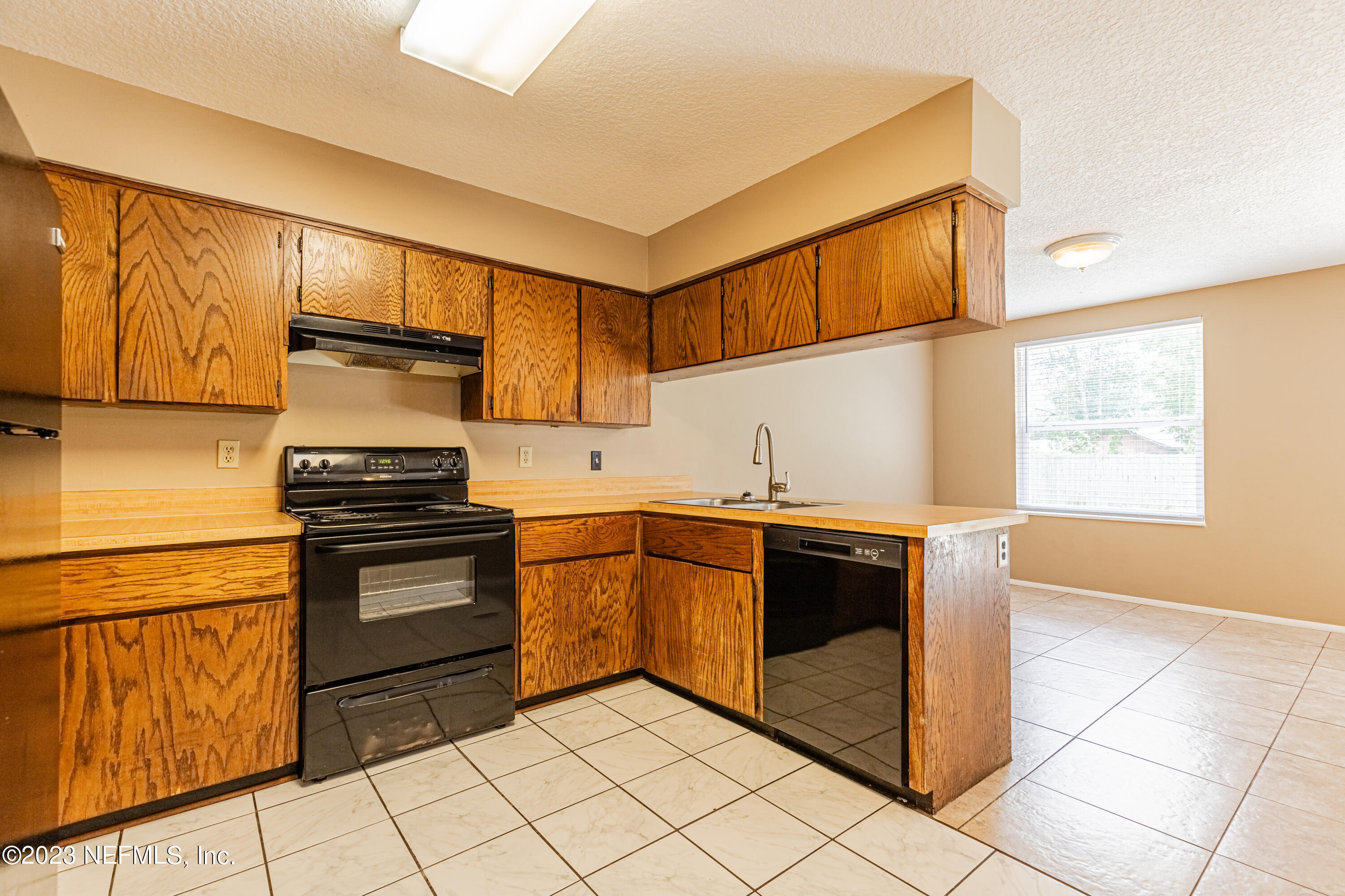 2833 Homestead Road Orange Park, FL 32065 - Photo 11 of 28 a kitchen with stainless steel appliances granite countertop a stove a sink and a microwave