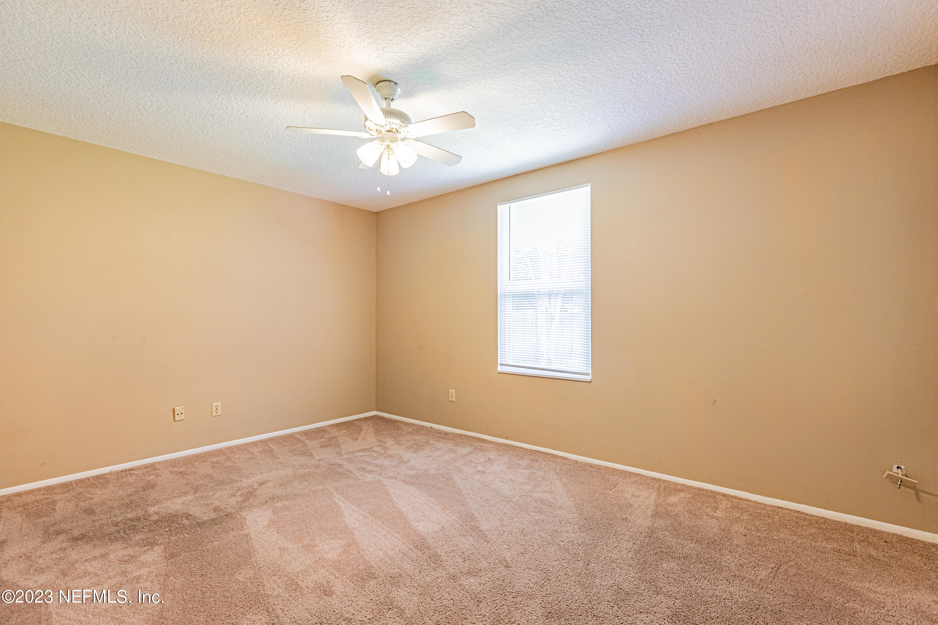 2833 Homestead Road Orange Park, FL 32065 - Photo 12 of 28 an empty room with a window and a fan