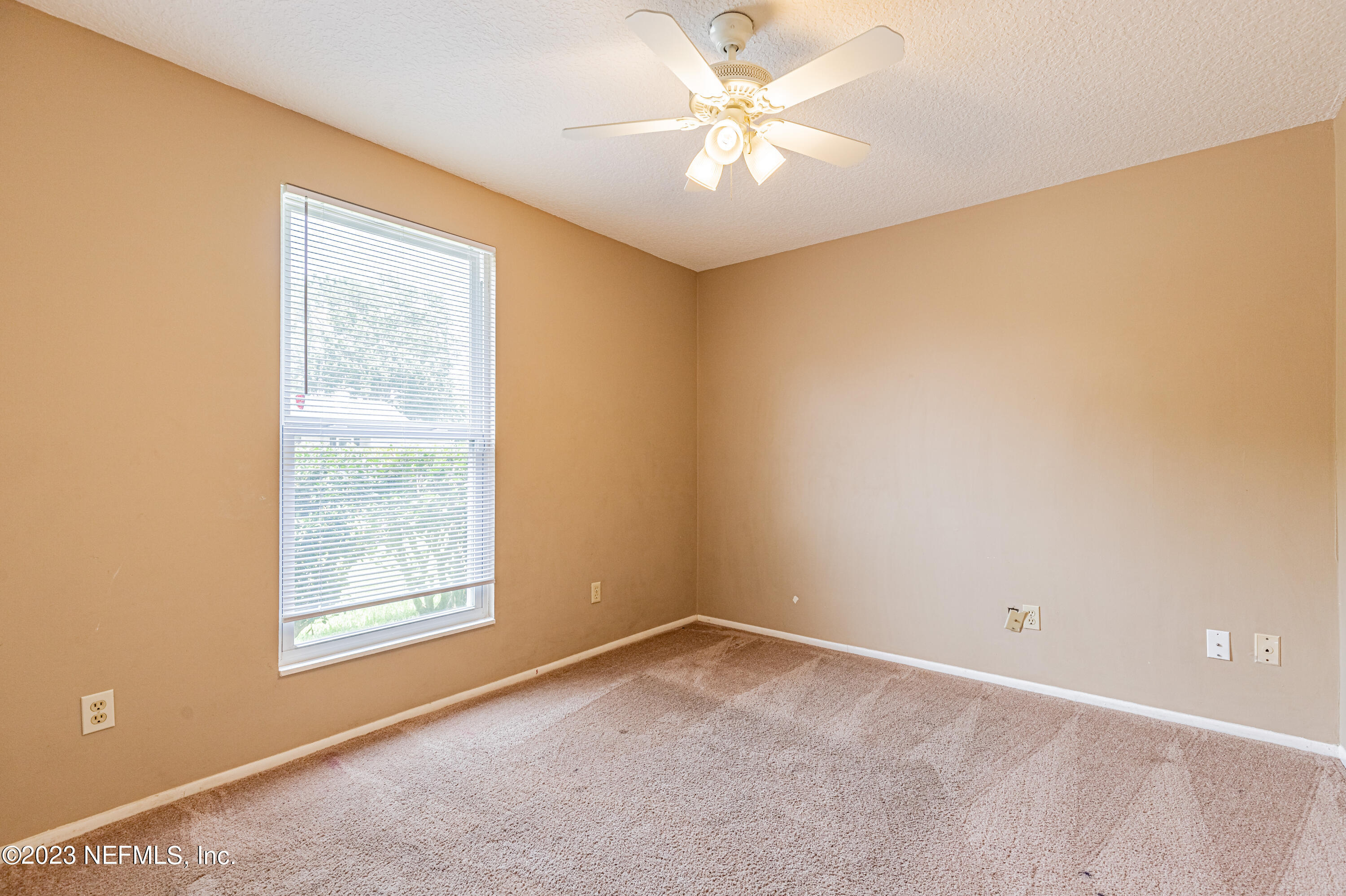 2833 Homestead Road Orange Park, FL 32065 - Photo 21 of 28 an empty room with a window and a ceiling fan