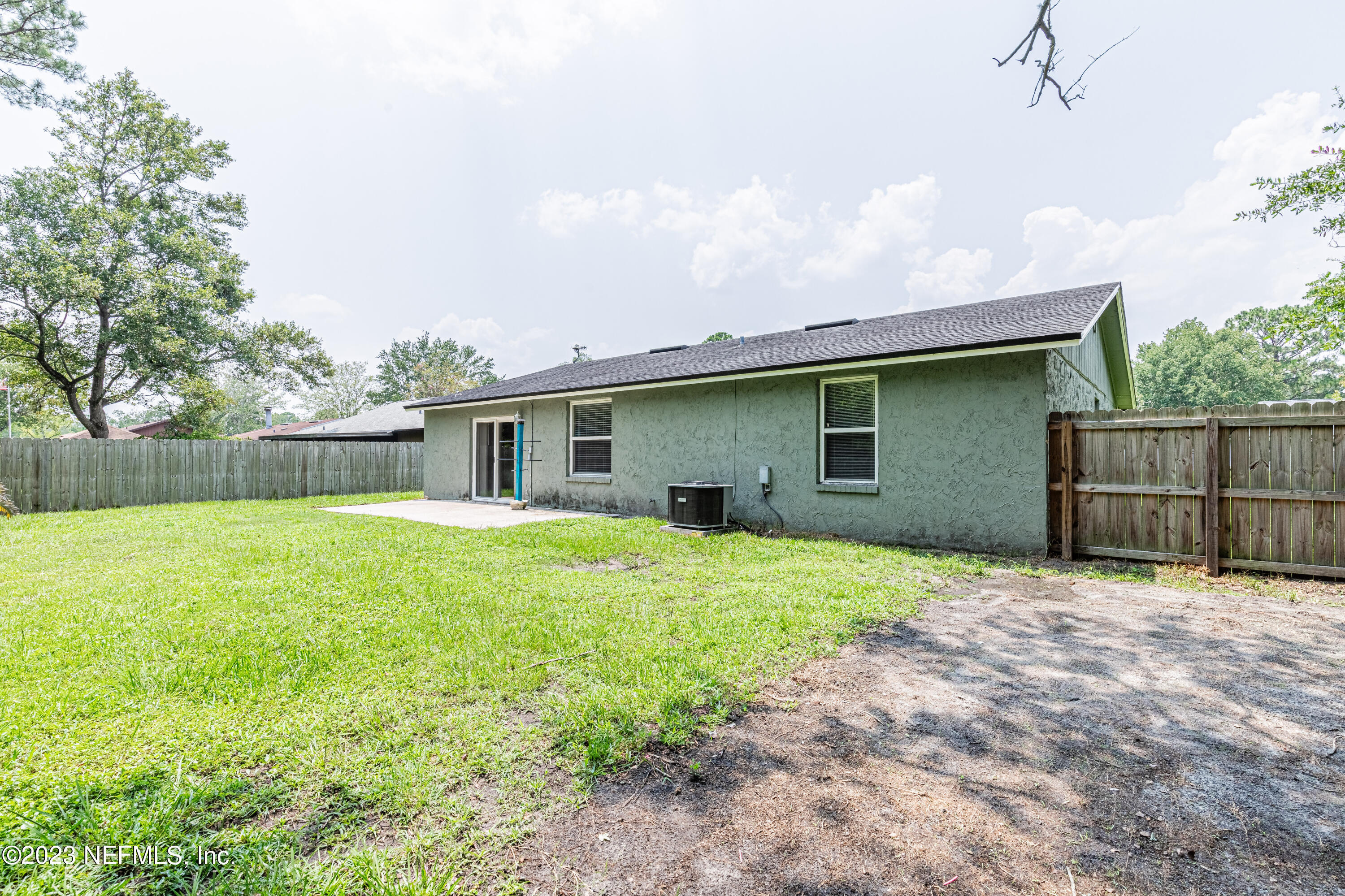 2833 Homestead Road Orange Park, FL 32065 - Photo 25 of 28 a backyard of a house with large trees and barbeque oven