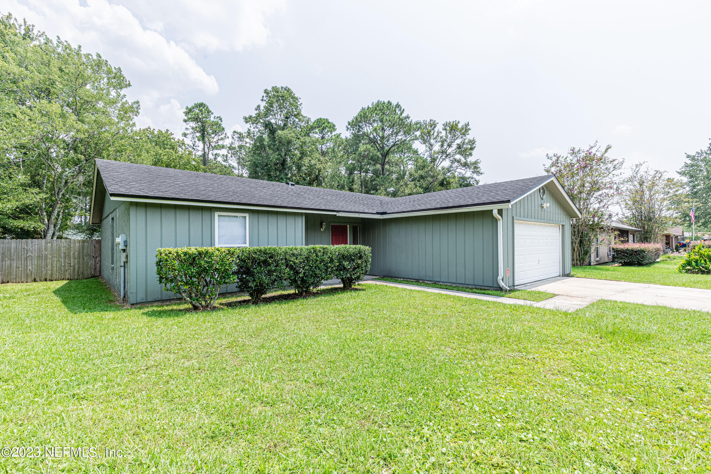 2833 Homestead Road Orange Park, FL 32065 - Photo 27 of 28 a view of a house with a yard and garage