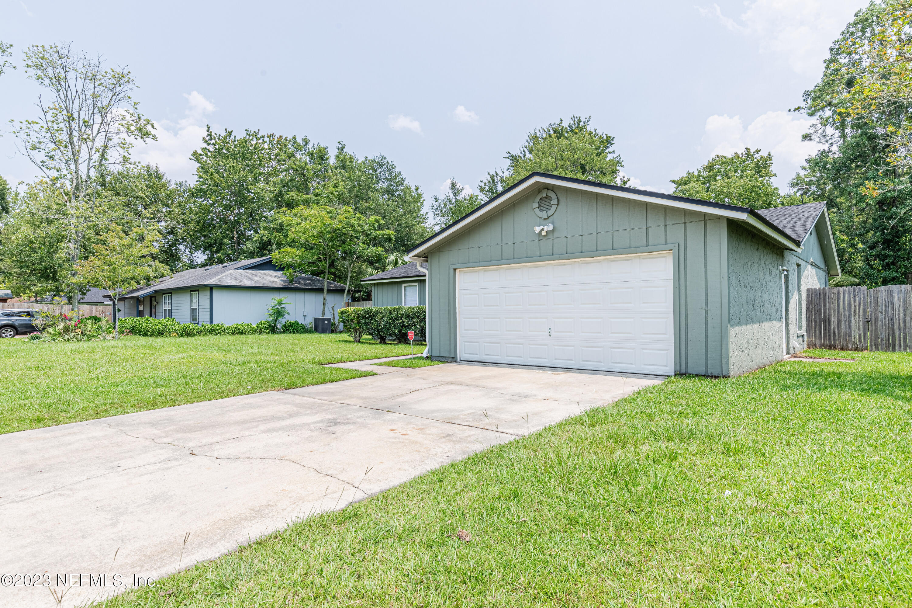2833 Homestead Road Orange Park, FL 32065 - Photo 28 of 28 a front view of a house with a yard and garage