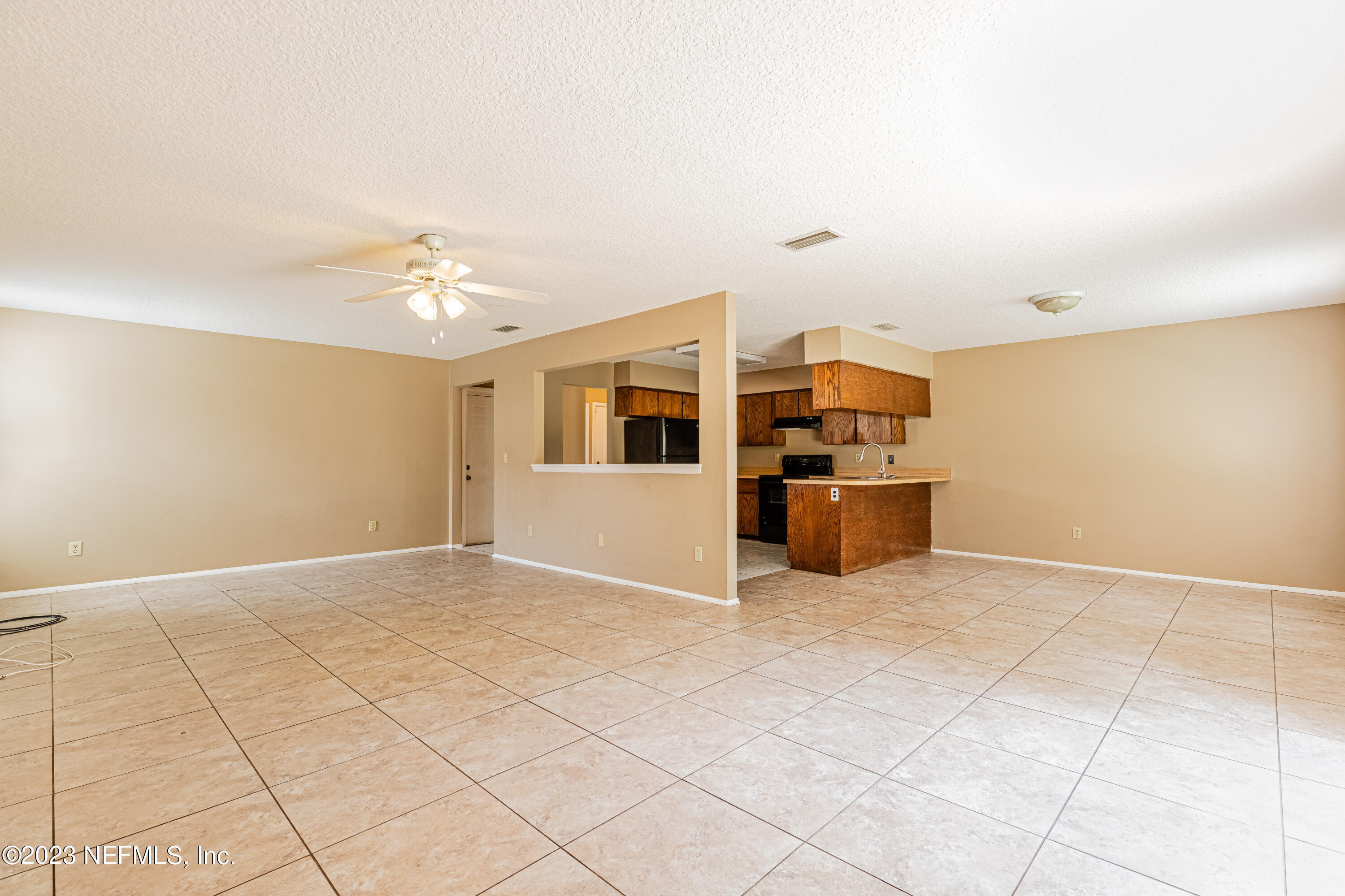 2833 Homestead Road Orange Park, FL 32065 - Photo 5 of 28 a view of a kitchen with furniture and an empty room