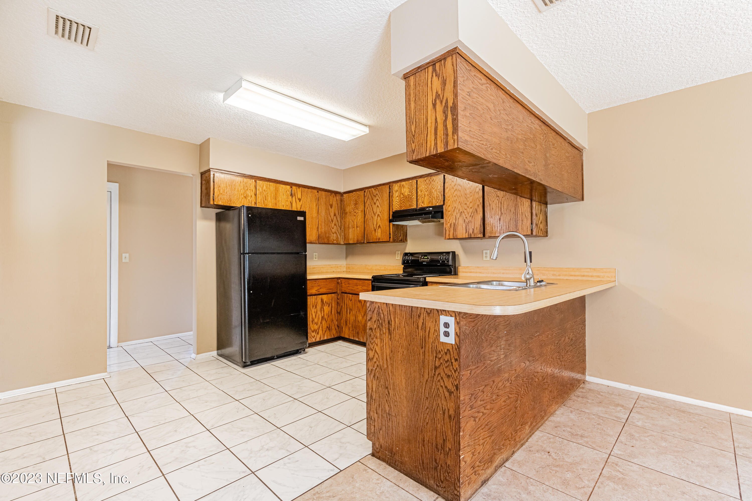 2833 Homestead Road Orange Park, FL 32065 - Photo 9 of 28 a kitchen with stainless steel appliances a refrigerator and a stove