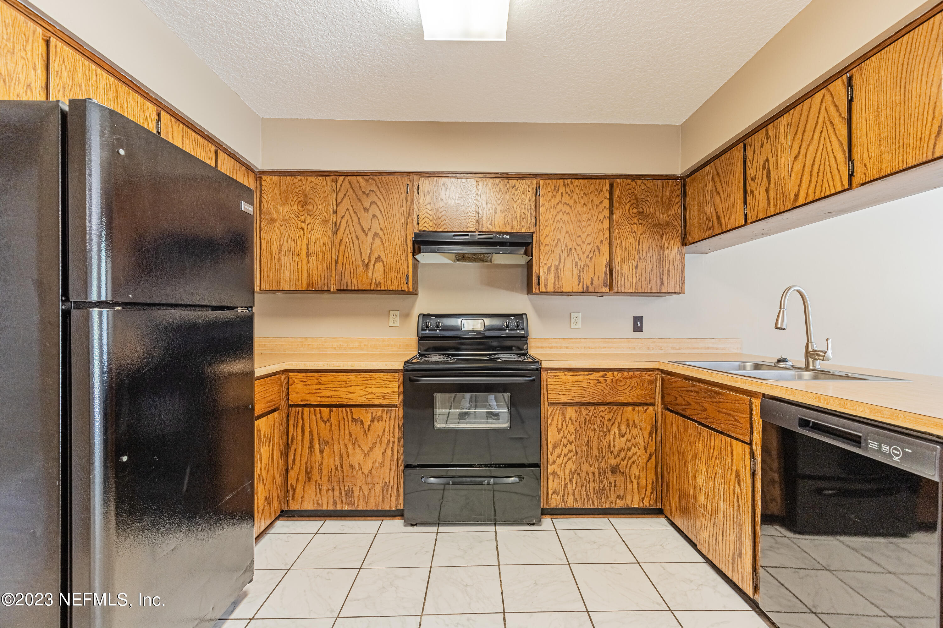 2833 Homestead Road Orange Park, FL 32065 - Photo 10 of 28 a kitchen with stainless steel appliances granite countertop a refrigerator and a sink
