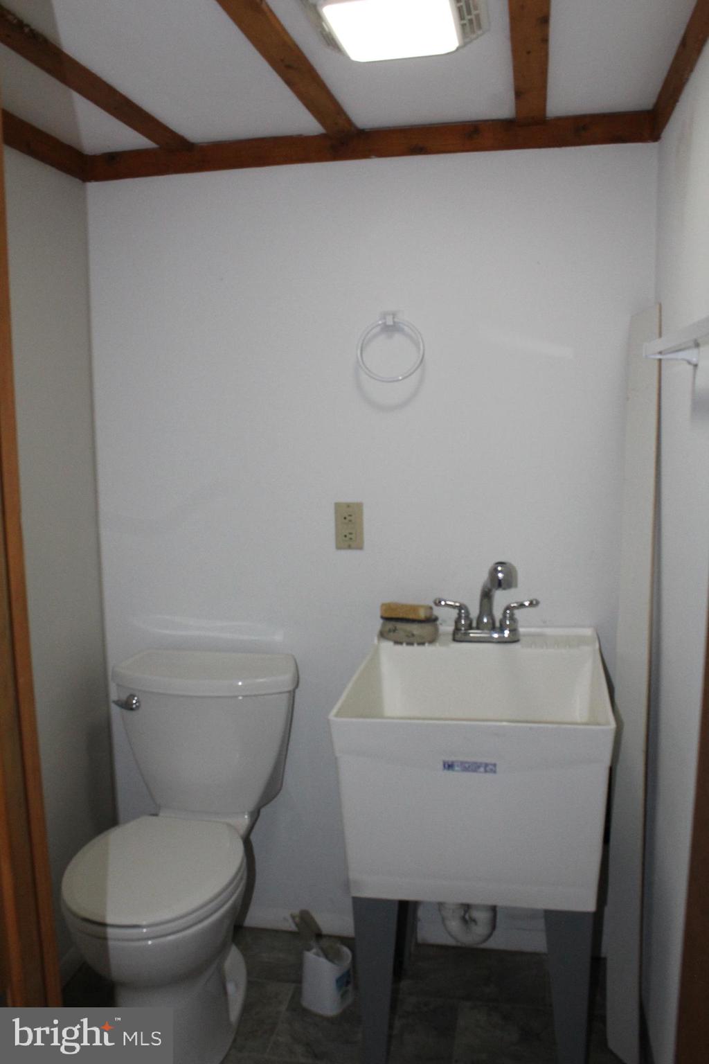 4529 Devonshire Road Harrisburg, PA 17109 - Photo 18 of 22 a bathroom with a toilet a sink and a window