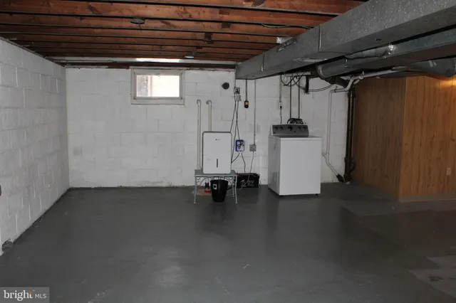 a view of water heater room with stairs