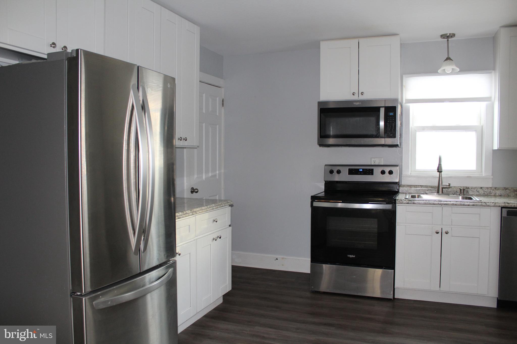 4529 Devonshire Road Harrisburg, PA 17109 - Photo 3 of 22 a kitchen with stainless steel appliances a refrigerator microwave and sink