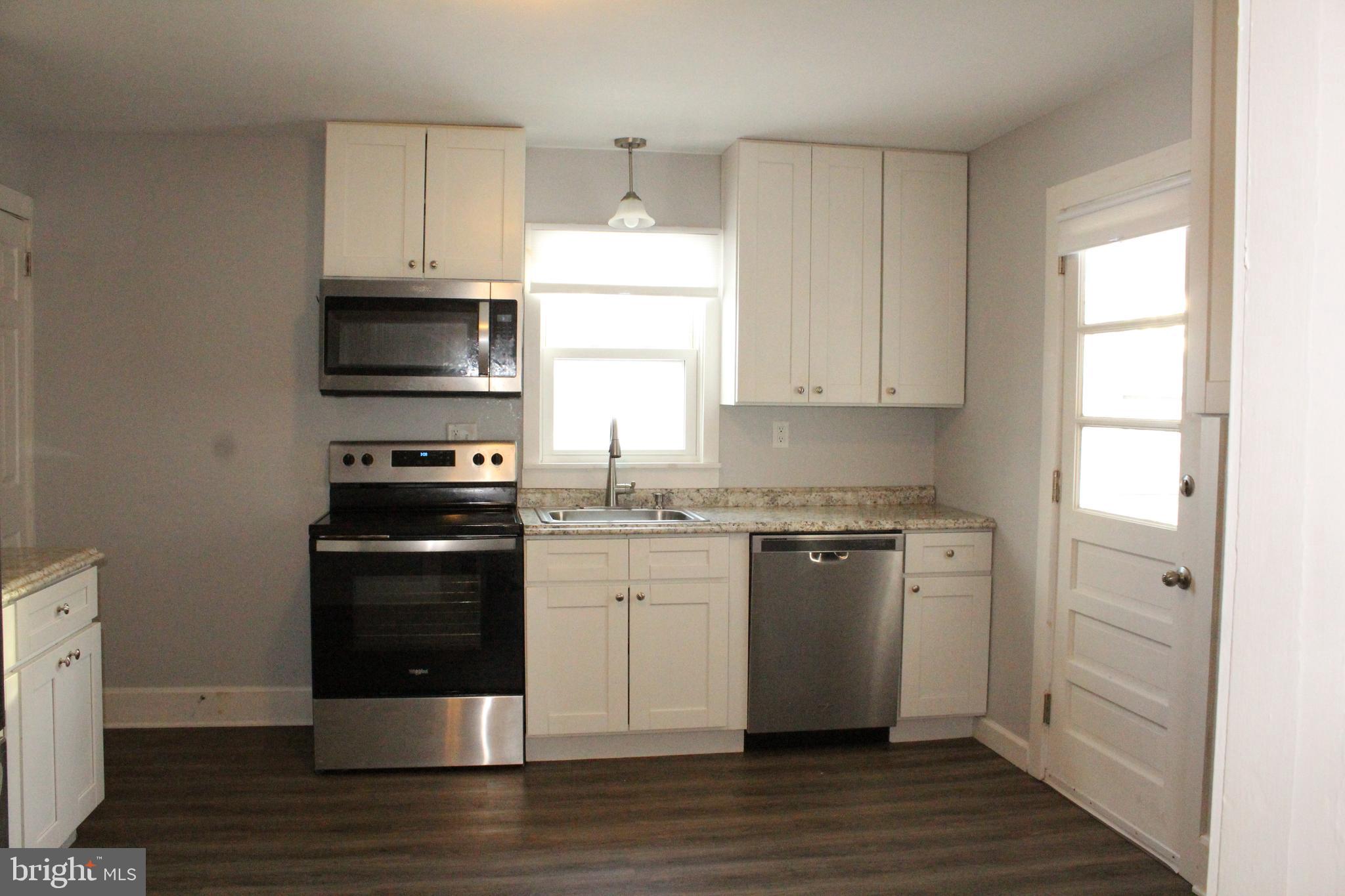 4529 Devonshire Road Harrisburg, PA 17109 - Photo 5 of 22 a kitchen with stainless steel appliances a stove microwave and refrigerator