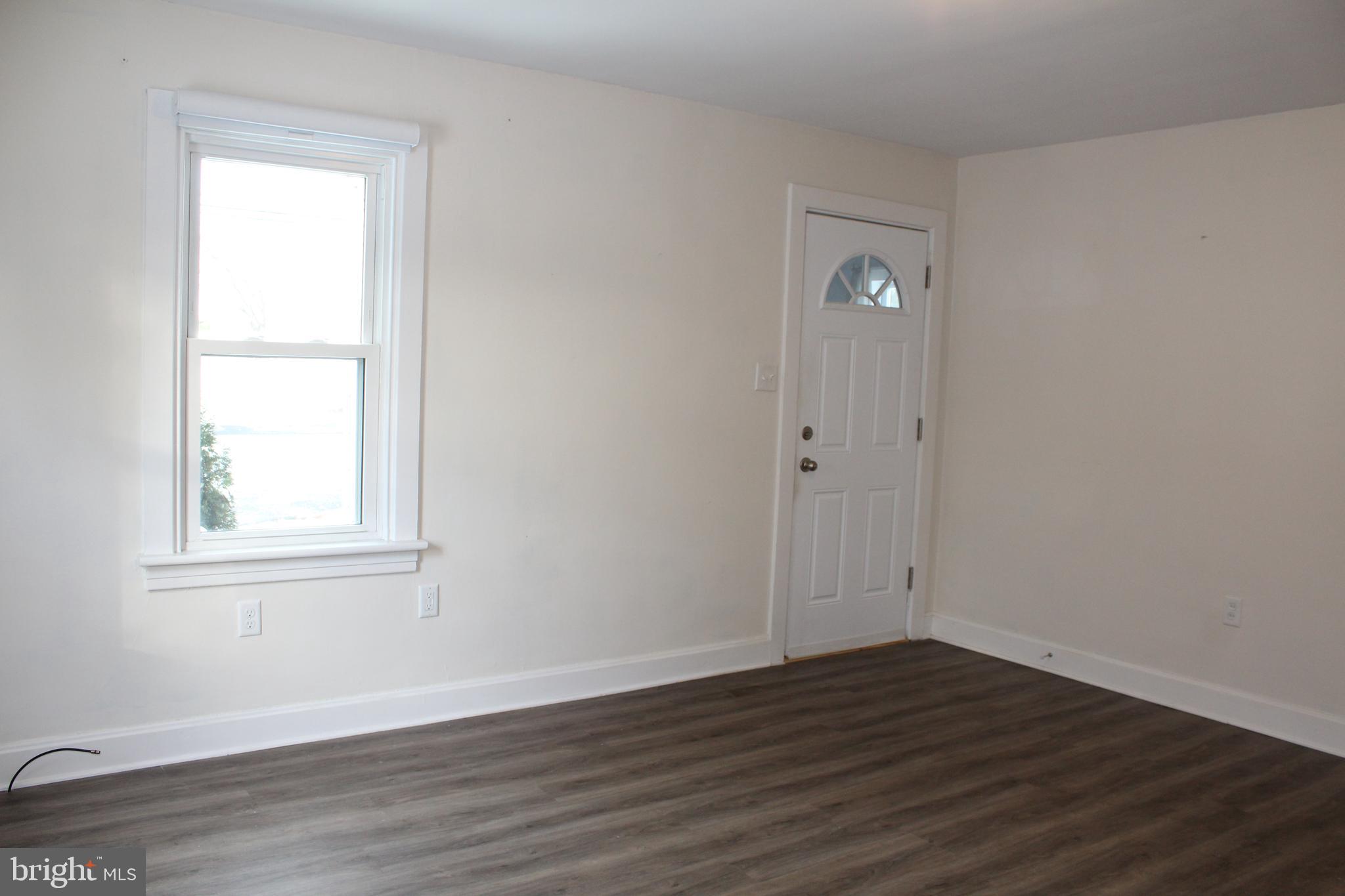4529 Devonshire Road Harrisburg, PA 17109 - Photo 6 of 22 an empty room with wooden floor and windows