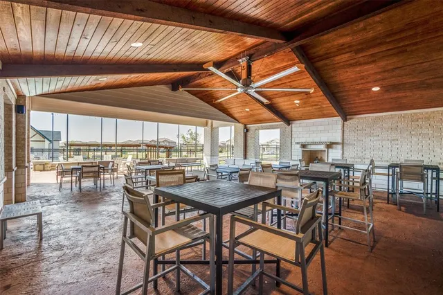 a kitchen with stainless steel appliances granite countertop a kitchen island a stove a table and chairs in it