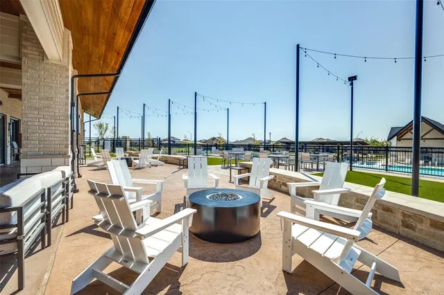 a swimming pool with outdoor seating and yard