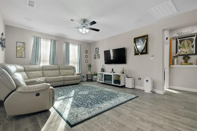 a kitchen that has a lot of white cabinets and stainless steel appliances