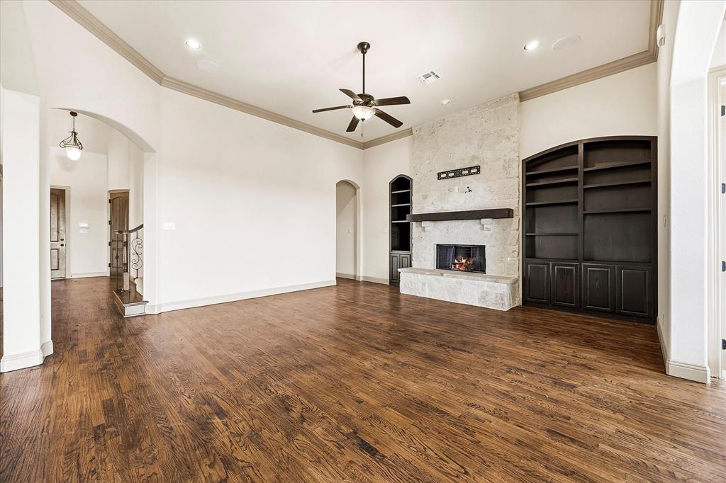 647 Gillon Way Rockwall, TX 75087 - Photo 13 of 40 Lovely floor to ceiling stone fireplace and custom built ins adorn the family room