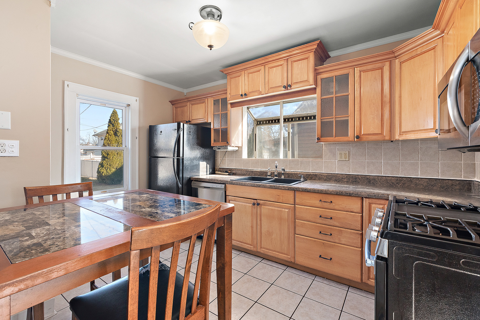 3316 Ann Street Lansing, IL 60438 - Photo 7 of 21 a kitchen with stainless steel appliances granite countertop a stove a sink dishwasher and cabinets with wooden floor