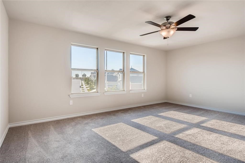 11608 Roxburgh Pass Austin, TX 78754 - Photo 6 of 12 an empty room with windows and fan