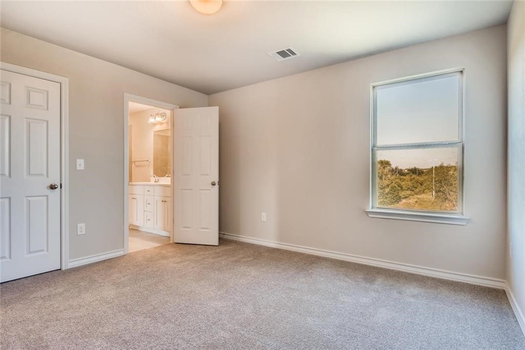 11608 Roxburgh Pass Austin, TX 78754 - Photo 7 of 12 an empty room with windows and closet