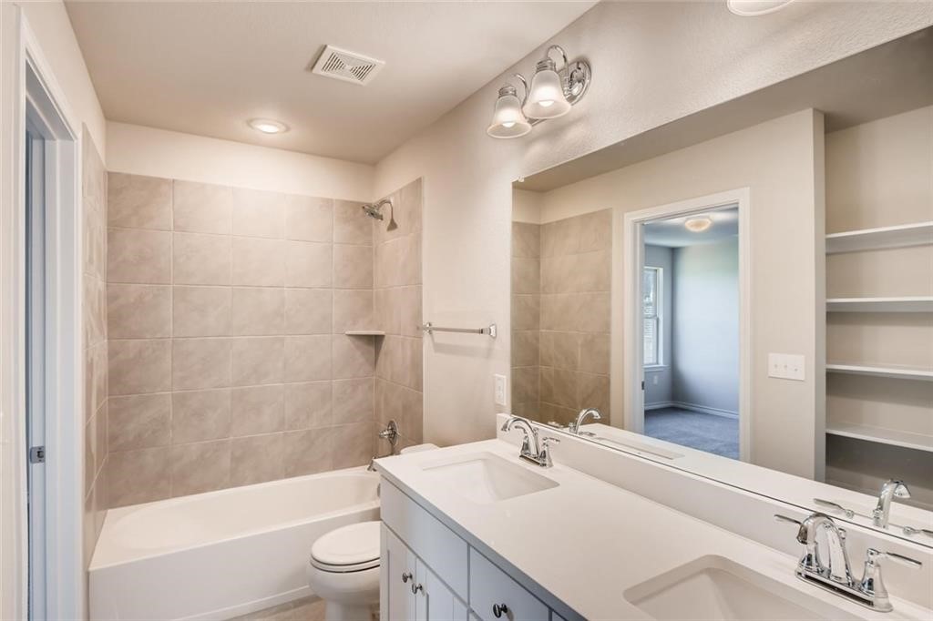 11608 Roxburgh Pass Austin, TX 78754 - Photo 10 of 12 a bathroom with a sink a toilet and shower