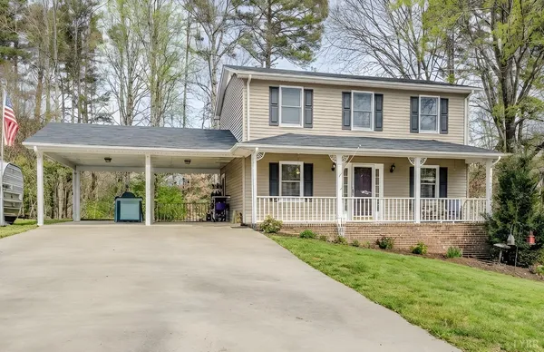a front view of a house with a yard and plants