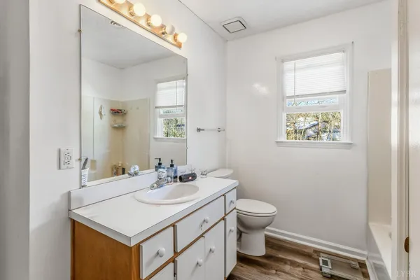 a bathroom with a sink toilet and a mirror