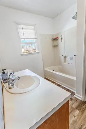 a bath tub sitting next to a white sink