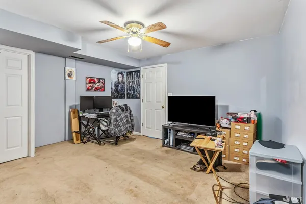 a living room with furniture a rug and a flat screen tv