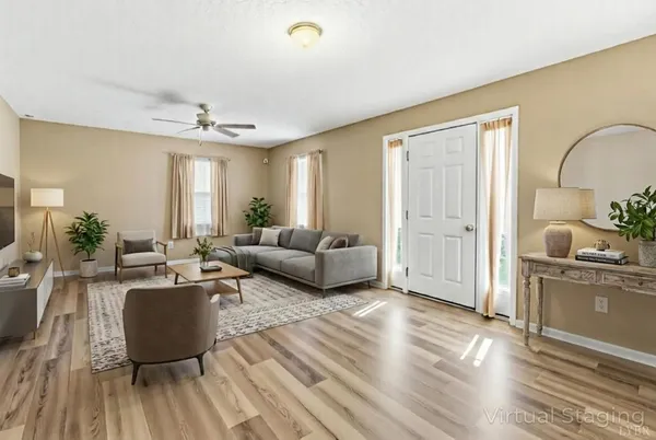a living room with furniture and a wooden floor