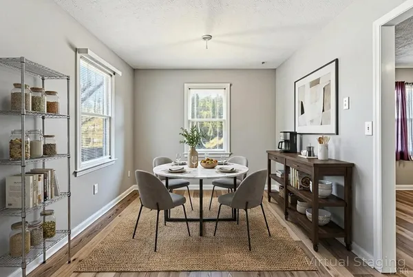 a view of a dining room with furniture window and wooden floor