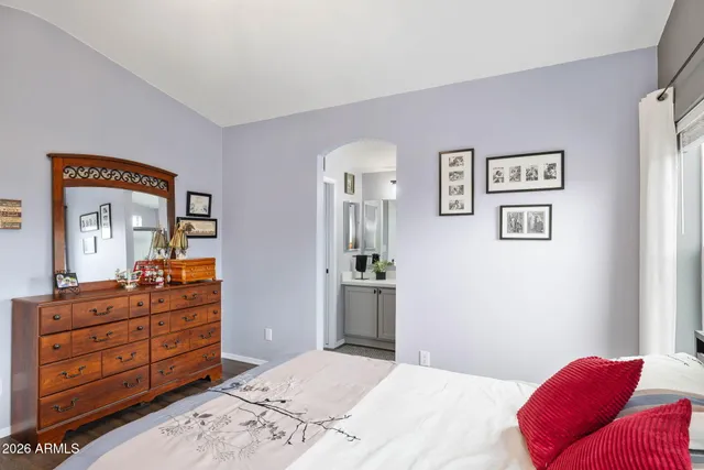 a bedroom with a bed and a dresser in it