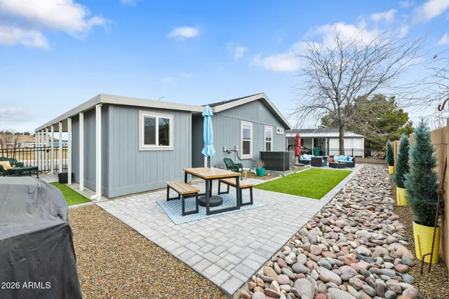 a backyard of a house with table and chairs