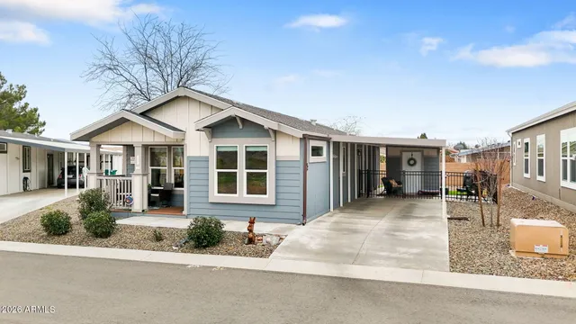 a front view of a house with yard and green space