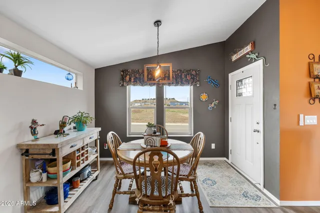 a dining room with furniture and window