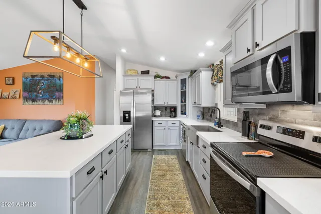 a kitchen with a sink stove and microwave